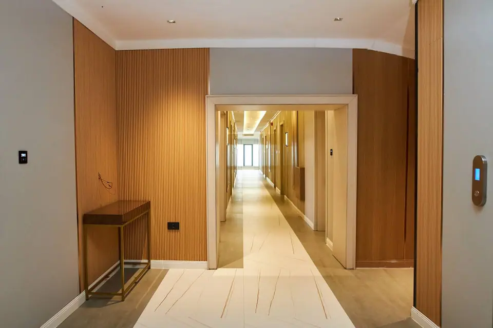 Floor lobby with fluted wood panelling and smart room controls