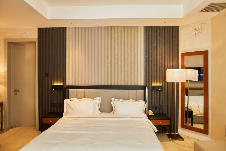 Presidential Suite bedroom with fluted headboard wall