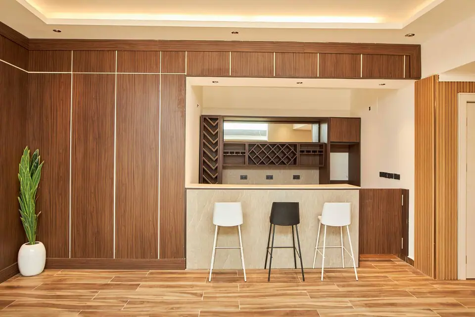 Sky Lounge Bar — warm wood interior with bar counter, wine rack and bar stools